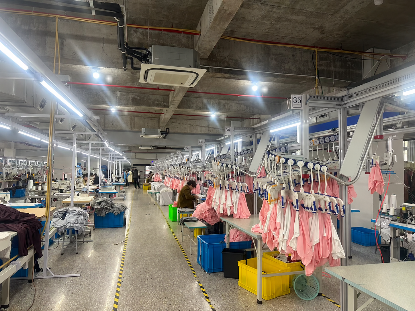 Garment production line with overhead garment handling